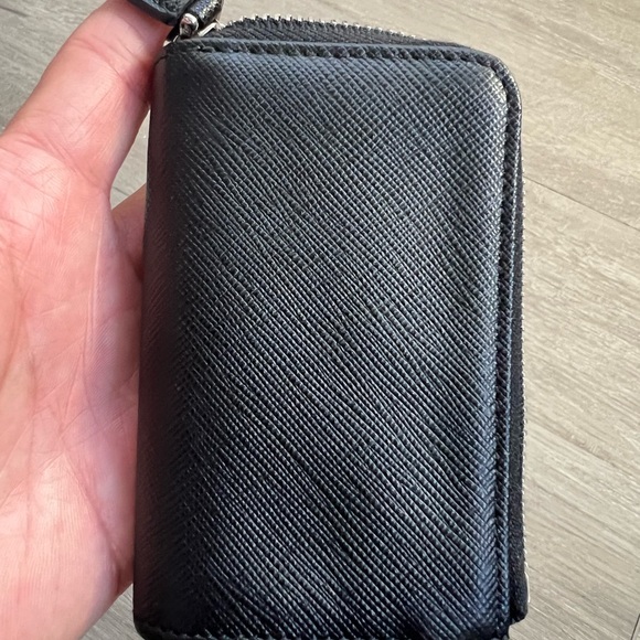 snap-hook and ring
Zipper closure
Enameled metal triangle logo
Two card slots - Picture 6 of 11